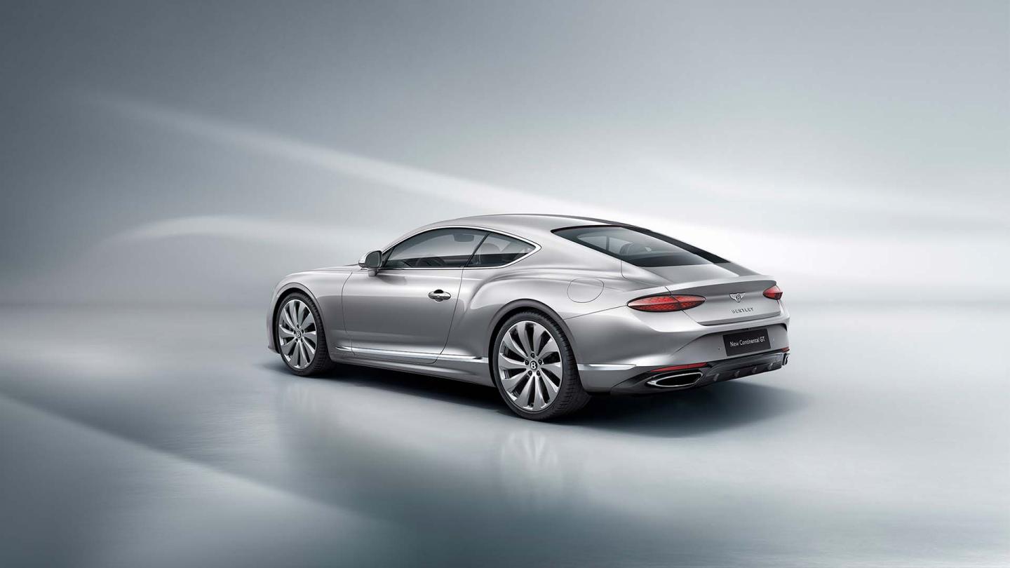 Rear three quarter  of the new hybrid Bentley Continental GT Mulliner with a Patina exterior colour and exclusive Mulliner 22" directional wheels