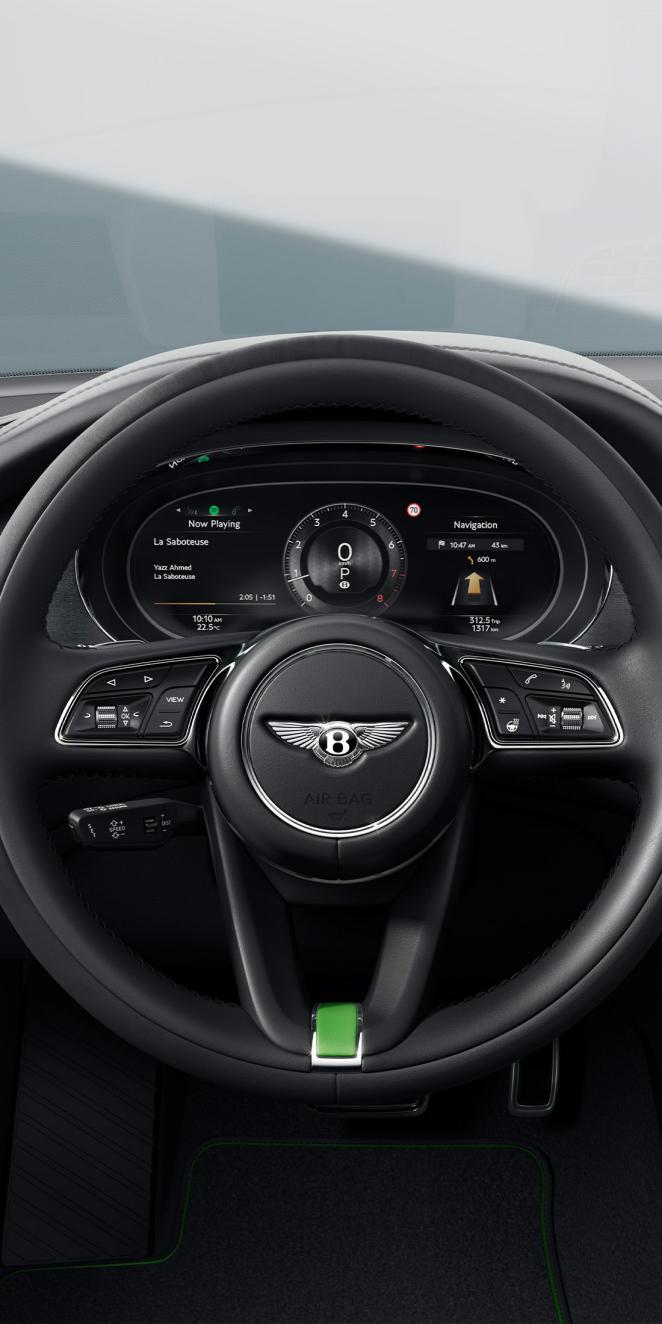 Driver POV of steering wheel which highlights a range of advanced driver assistance systems.