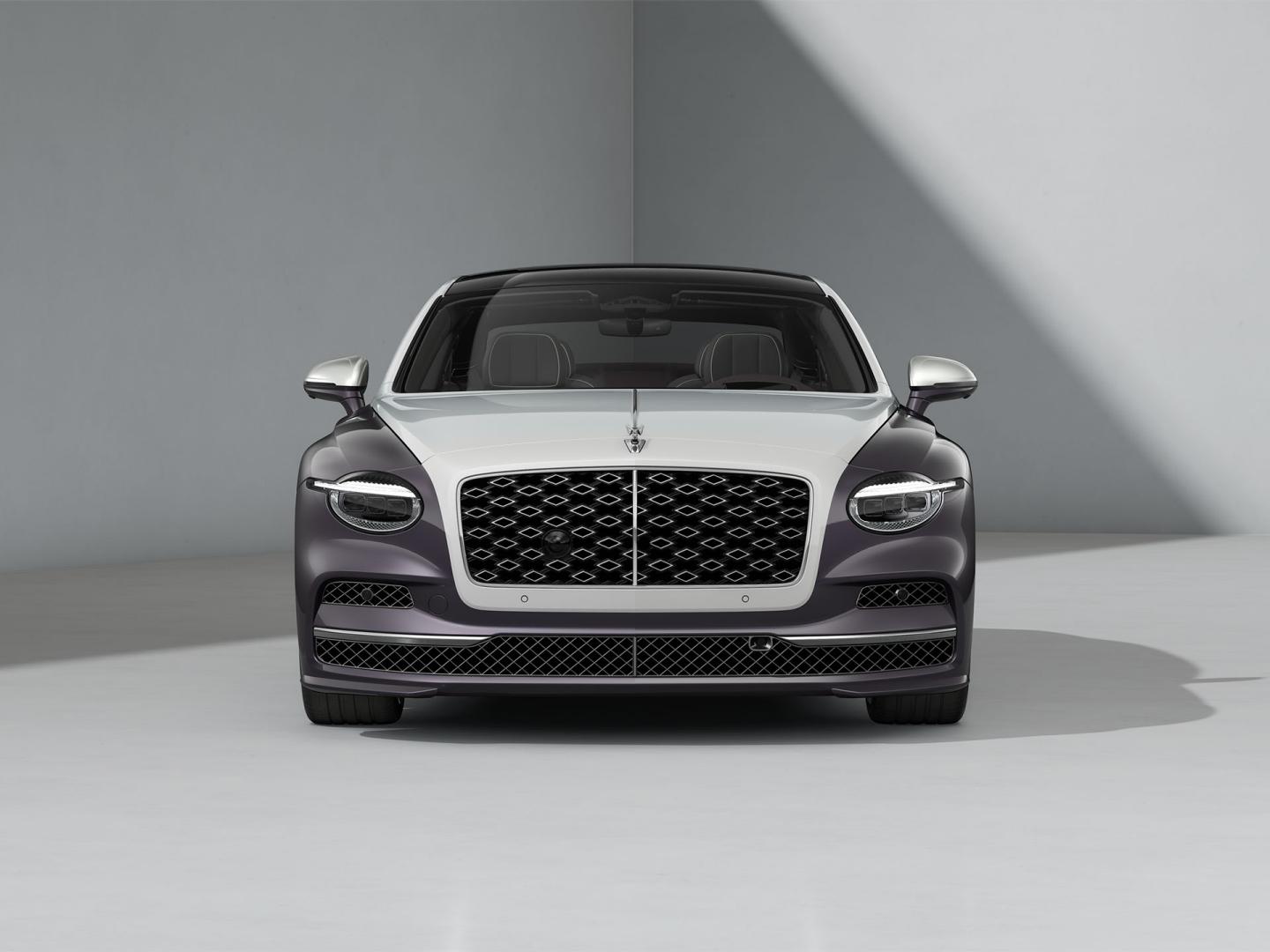Front-on shot of the Bentley Flying Spur Mulliner in Ice / Grey Violet with Bright Chrome exterior detailing.