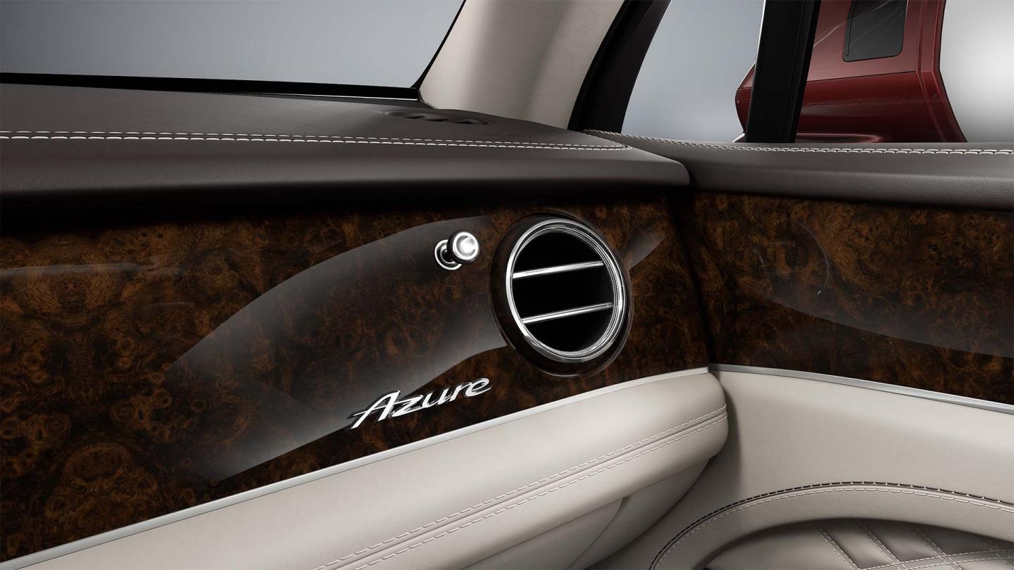 Bentley Bentayga EWB Azure SUV in Linen and Burnt Oak hides vent close up with Azure badging