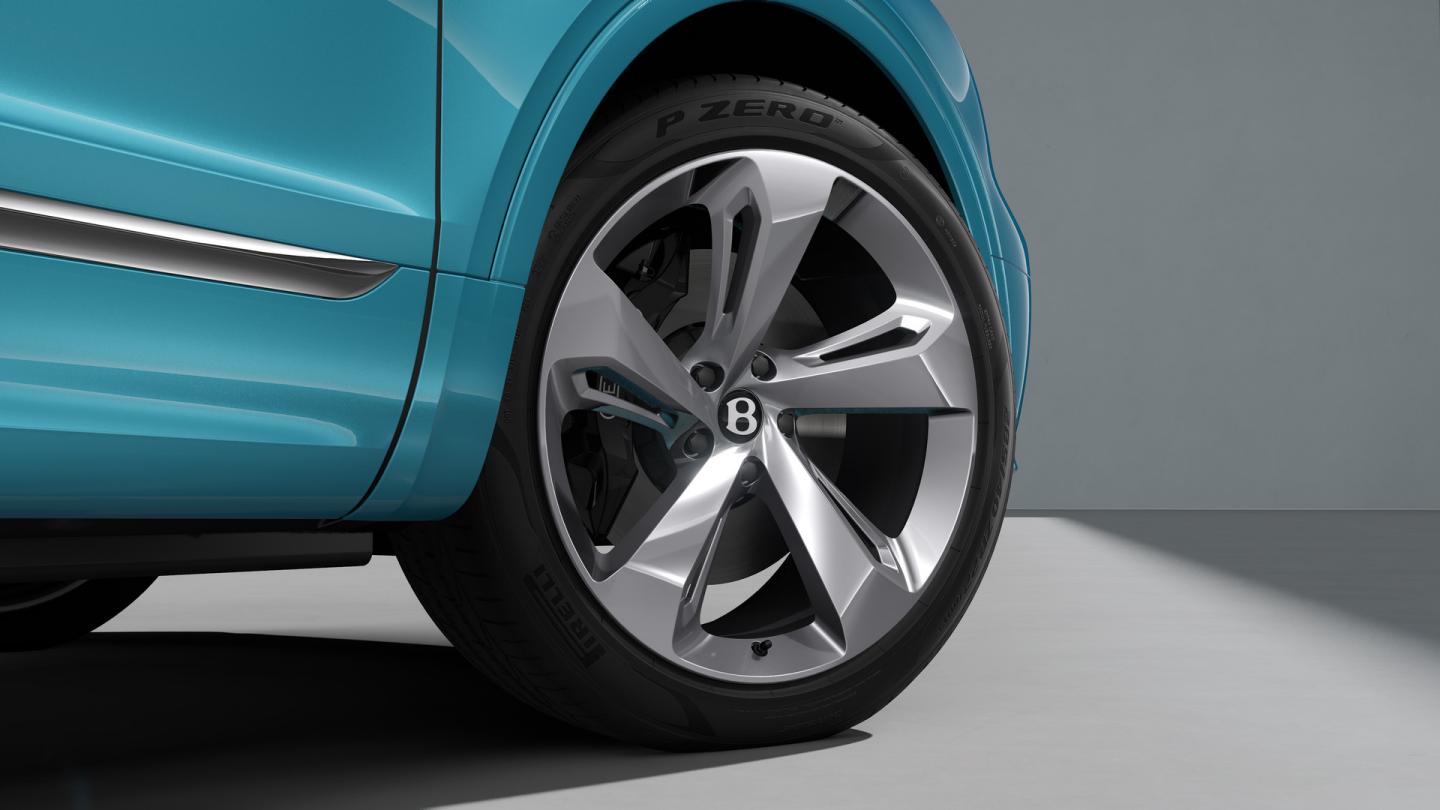 Bentley Bentayga EWB passenger side view overlooking Chrome metal bulls-eye air vents set in Crown Cut Walnut veneer.