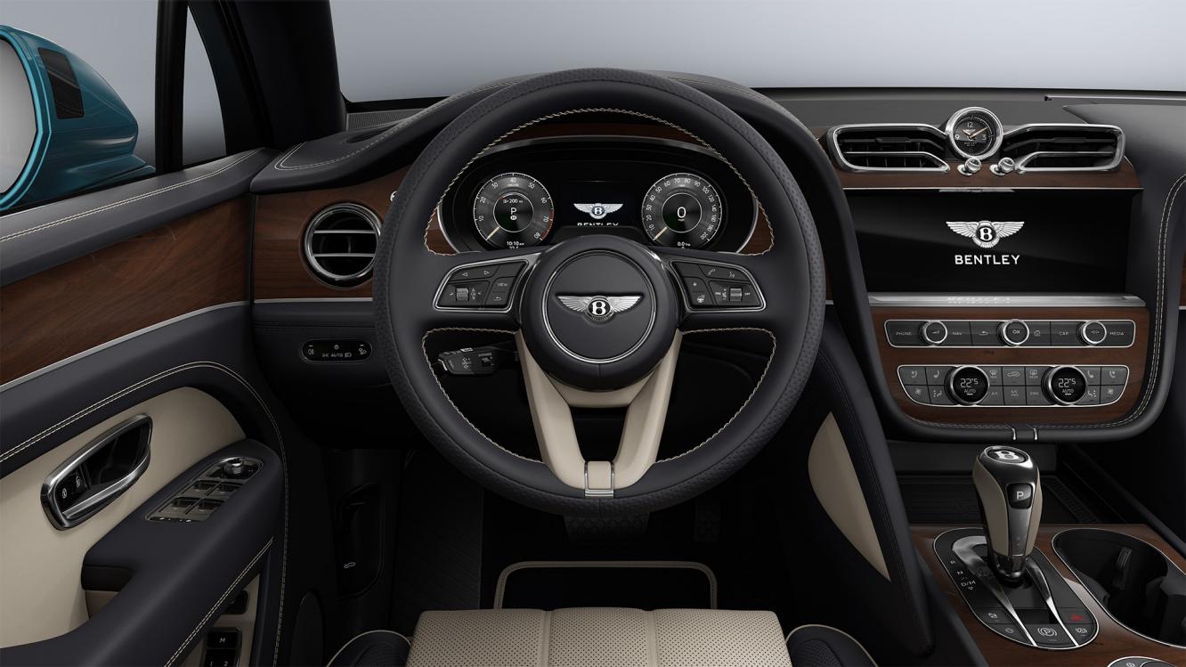 Rear passenger seat view of Bentley Bentayga EWB featuring Beluga hide and contrast stitching of Bentley emblem in Linen.