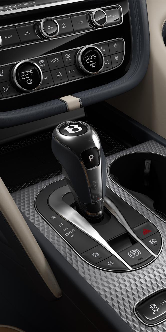 Bentley Bentayga EWB Mulliner SUV in Camel and Brunel hides with Portland accents and Grand Black with Mulliner Overlays and Aluminium Console veneer drive selector