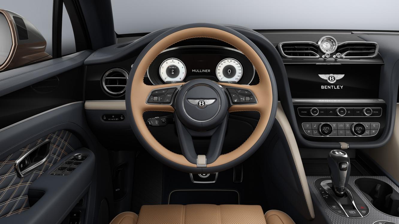 Drivers view of the steering wheel in a Bentayga EWB Mulliner featuring Camel main hide and Brunel secondary hide