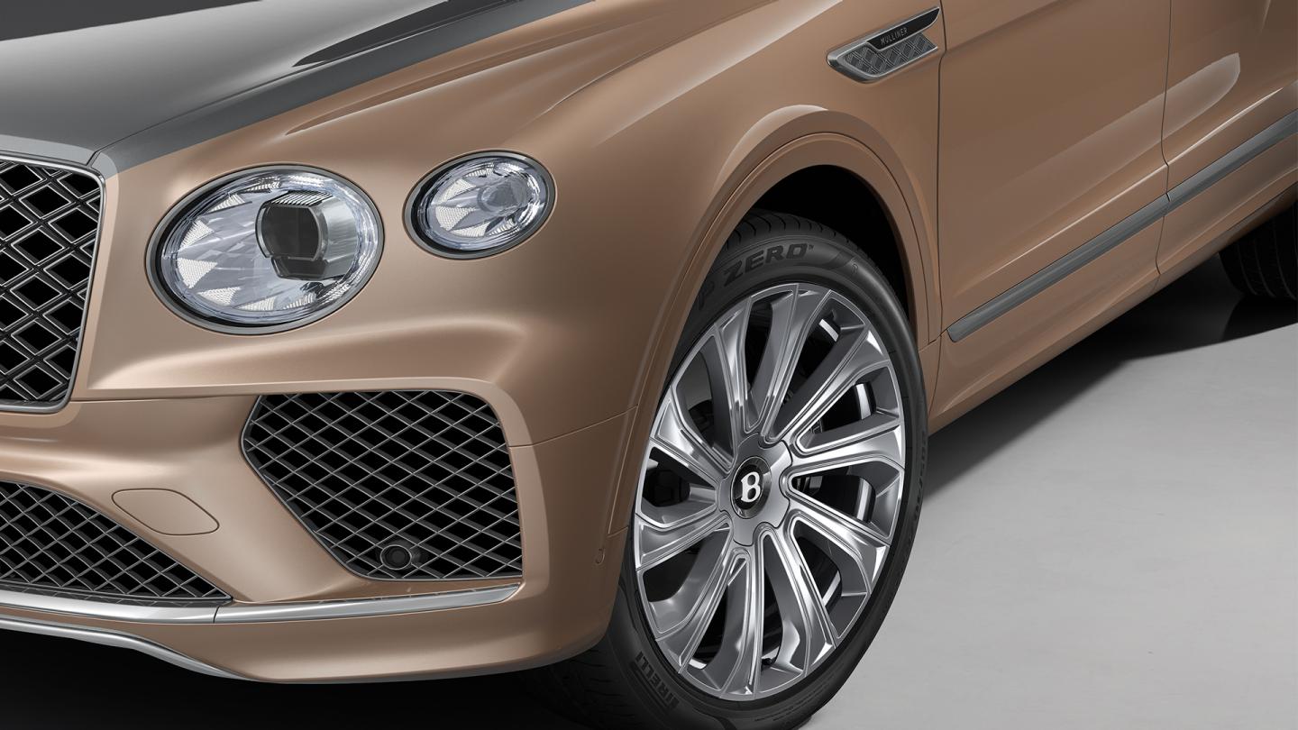 Close up of the 22" Mulliner Polished Wheel and Front headlight of the Bentley Bentayga EWB Mulliner