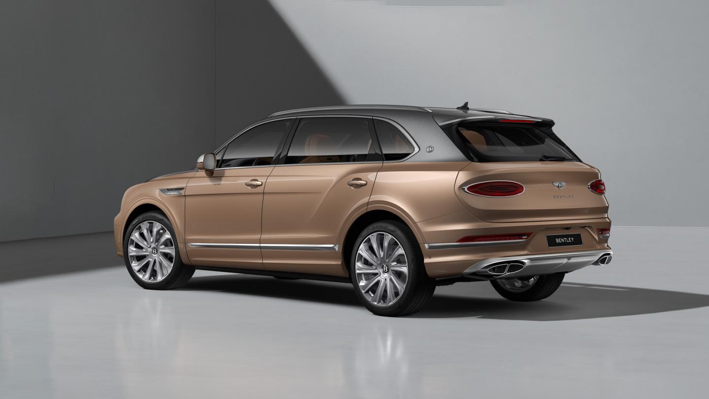 Rear three quarter of a Bentley Bentayga EWB Mulliner in Magnetic over Rose Gold