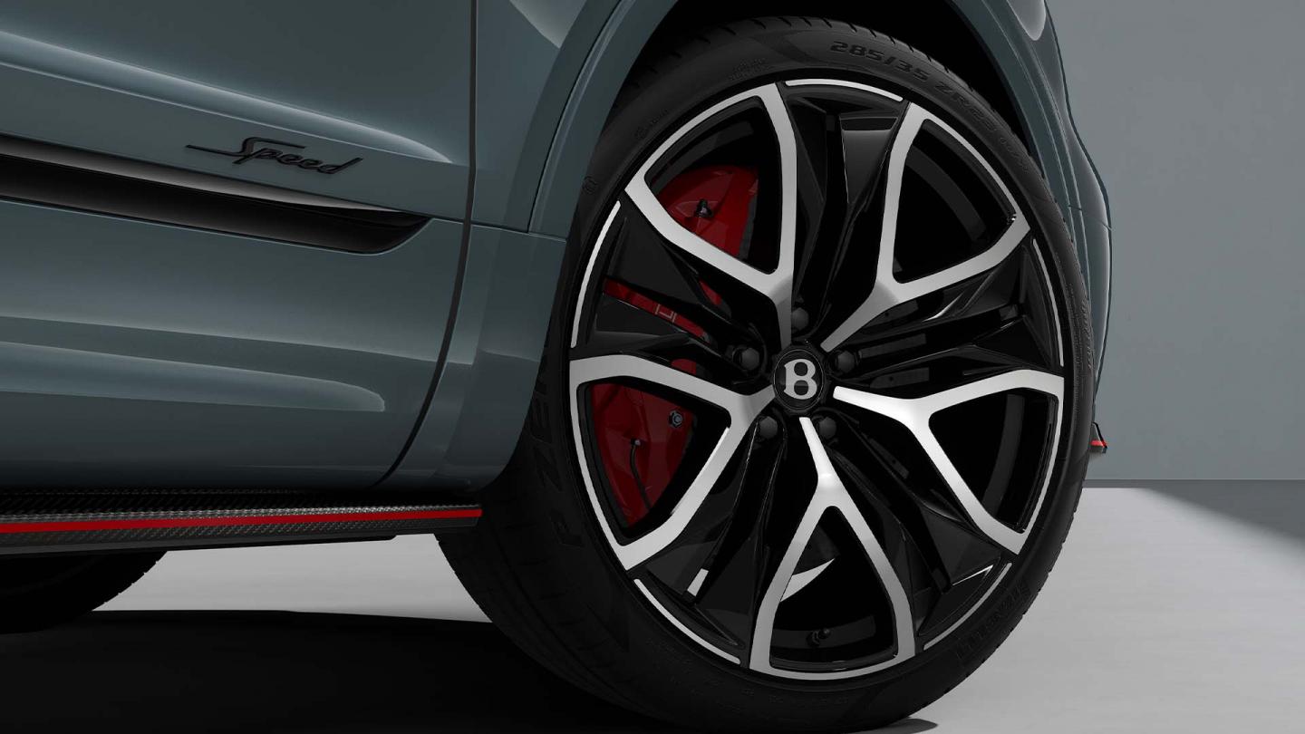 Bentley Bentayga Speed SUV in Storm Grey Satin paint with 23 inch Black Painted and Bright Machined Wheels image of front wheel with Speed badging