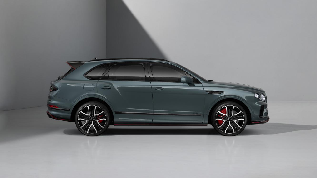 Side profile of a Bentley Bentayga Speed in Storm Grey Satin, featuring 23" Black Painted and Bright Machined Wheels