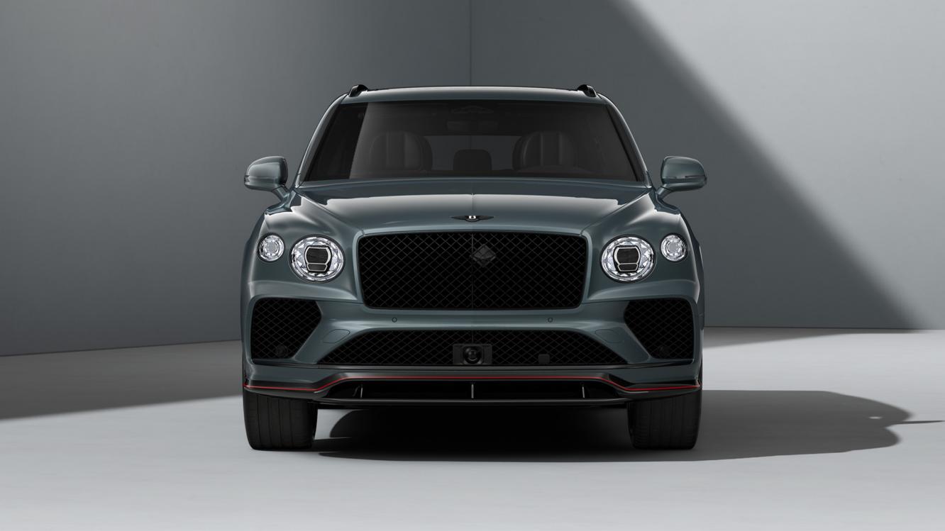 Front profile of a Bentley Bentayga Speed in Storm Grey Satin with a red accent on the carbon fibre body kit