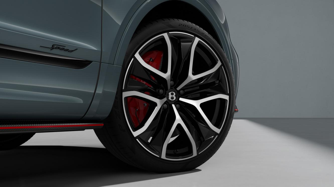 Bentley Bentayga Speed SUV in Storm Grey Satin paint with 23 inch Black Painted and Bright Machined Wheels close up image of the wheels