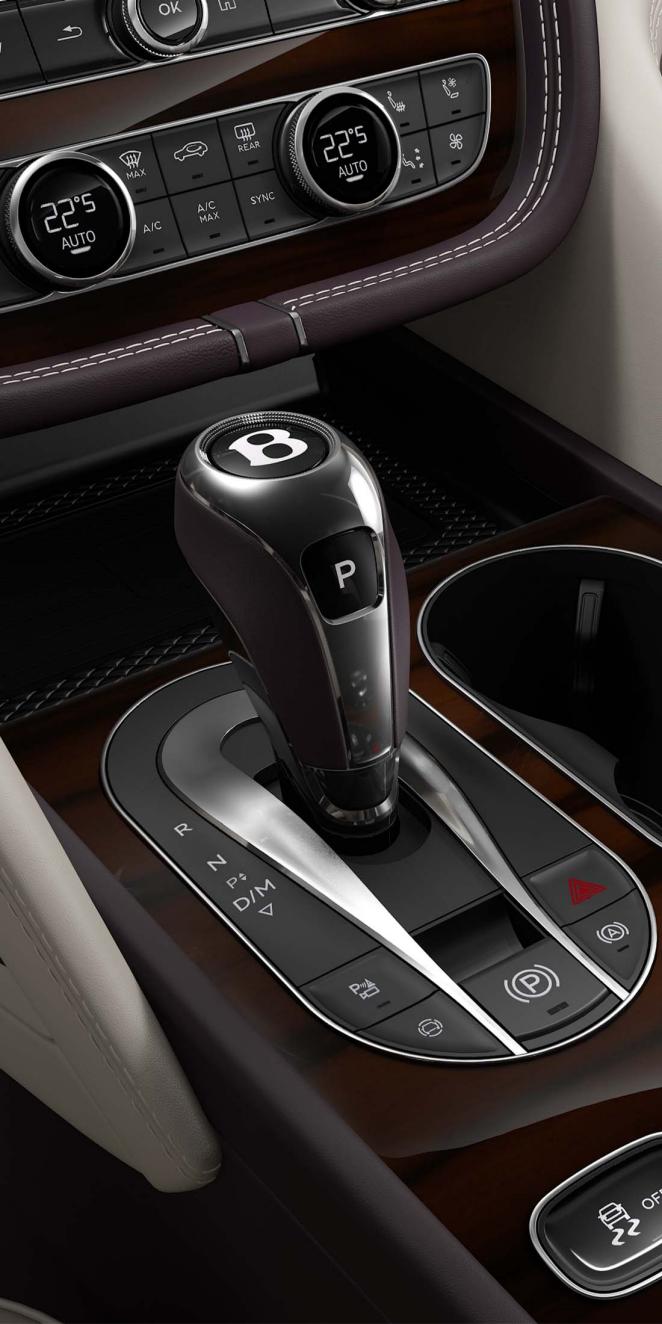 Bentley Bentayga Azure's 8 speed automatic transmission lever in focus set in Open Pore Koa veneer.