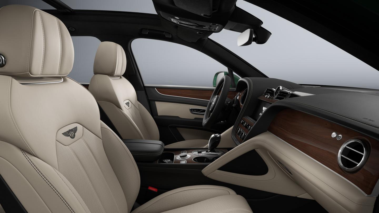 Front cabin of a Bentley Bentayga SUV with Portland main hide, Beluga secondary hide and Crown Cut Walnut Veneer