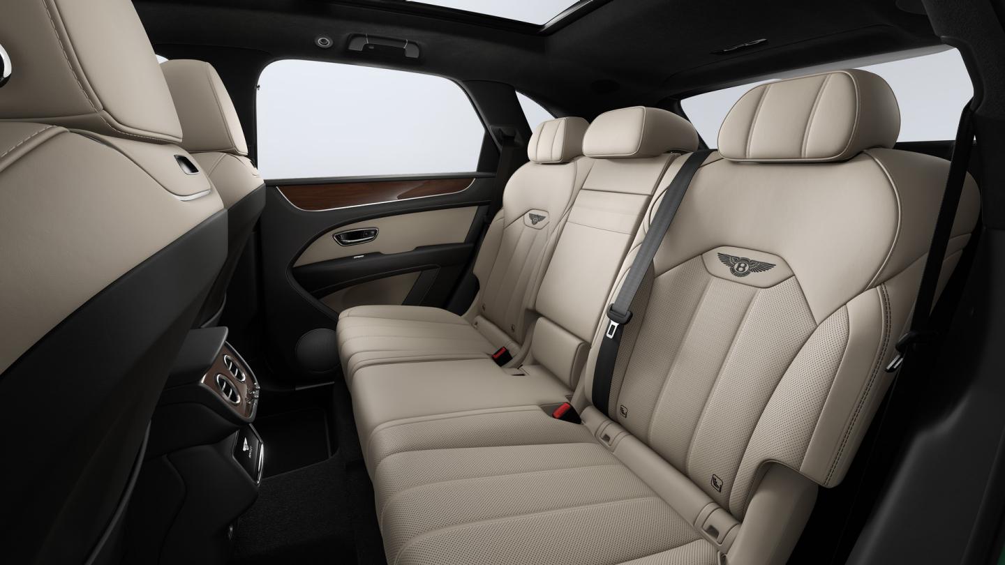Rear cabin of a Bentley Bentayga SUV with Portland main hide, Beluga secondary hide and Crown Cut Walnut Veneer