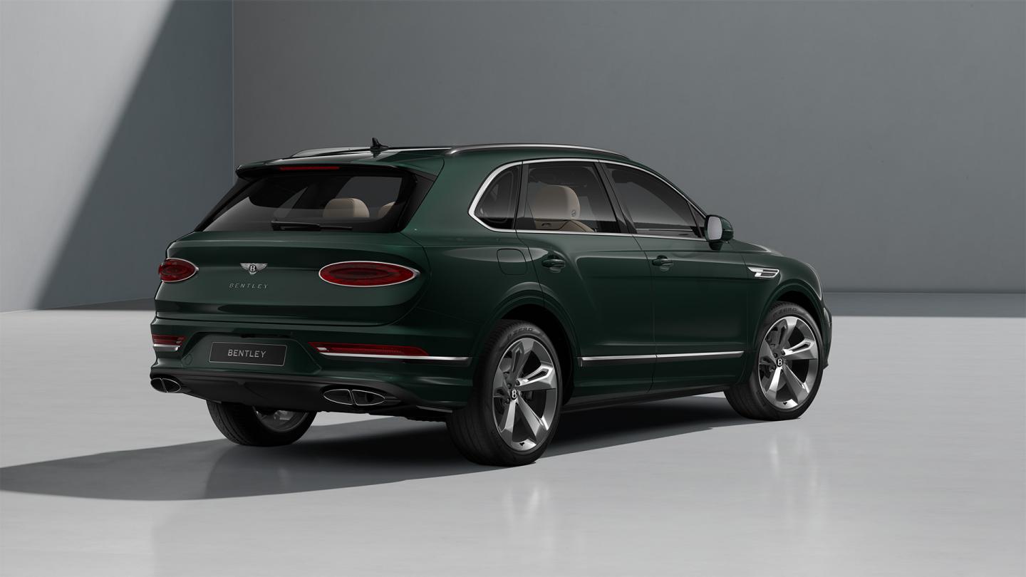 Rear three quarter of a Bentley Bentayga SUV in Verdant exterior paint with 22" five spoke directional and painted wheels