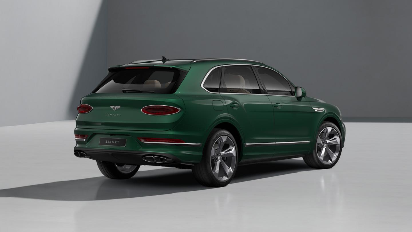 Rear three quarter of a Bentley Bentayga SUV in Verdant exterior paint with 22" five spoke directional and polished wheels