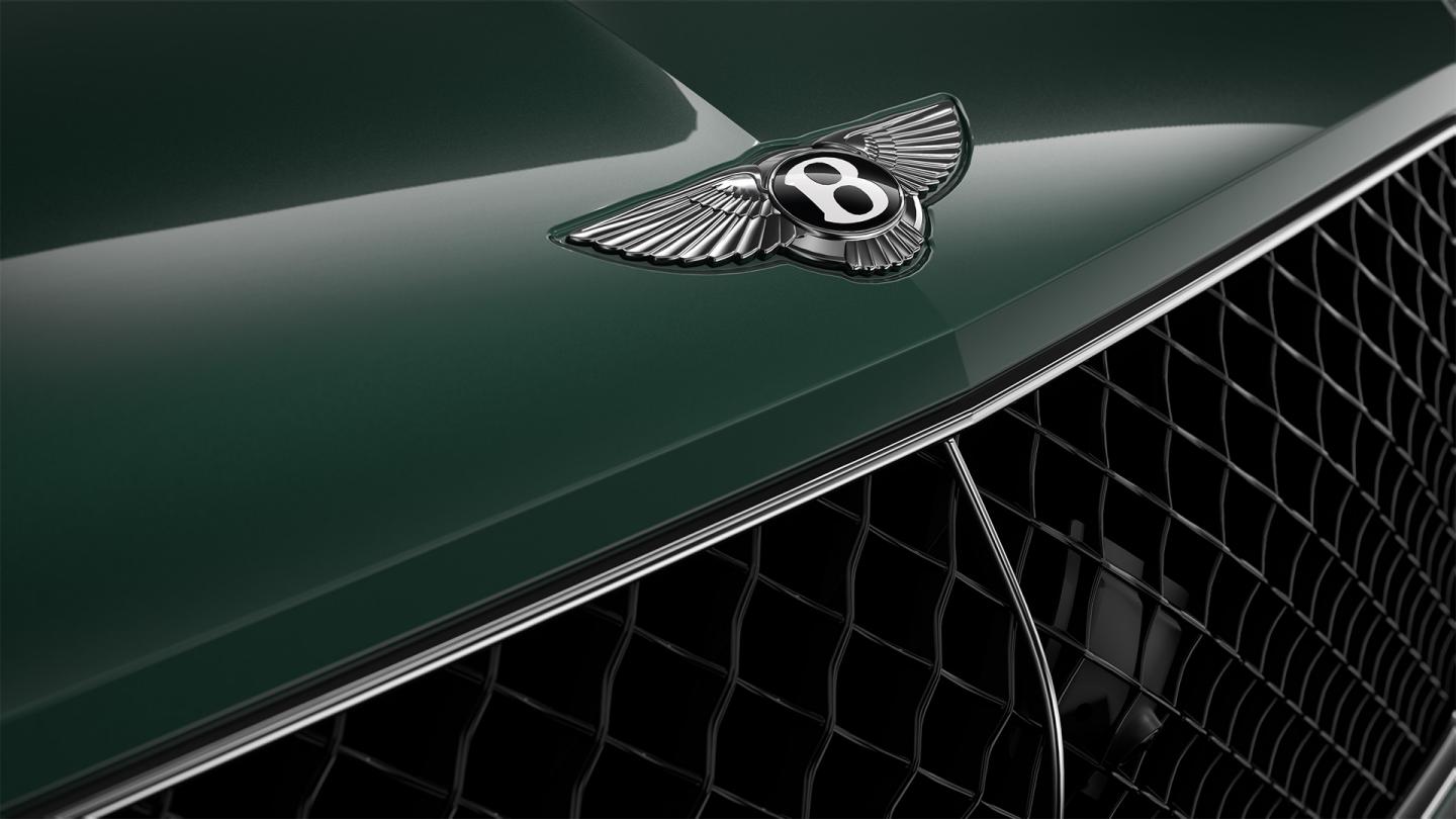 Close up of the Bentley wings on the bonnet of a Bentley Bentayga SUV in Verdant exterior paint