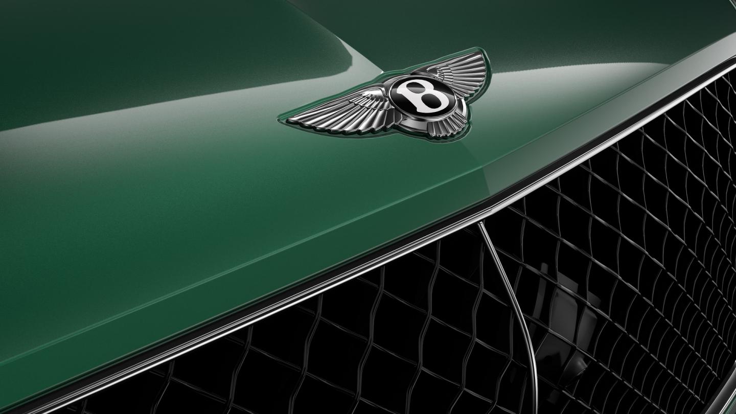 Close up of the Bentley wings on the bonnet of a Bentley Bentayga SUV in Verdant exterior paint