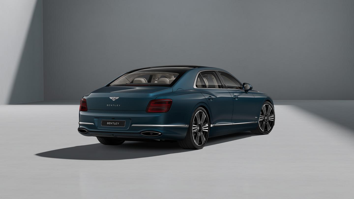 Rear three-quarter shot of the Bentley Flying Spur Azure in Dark Teal with Bright Chrome Exterior detailing.