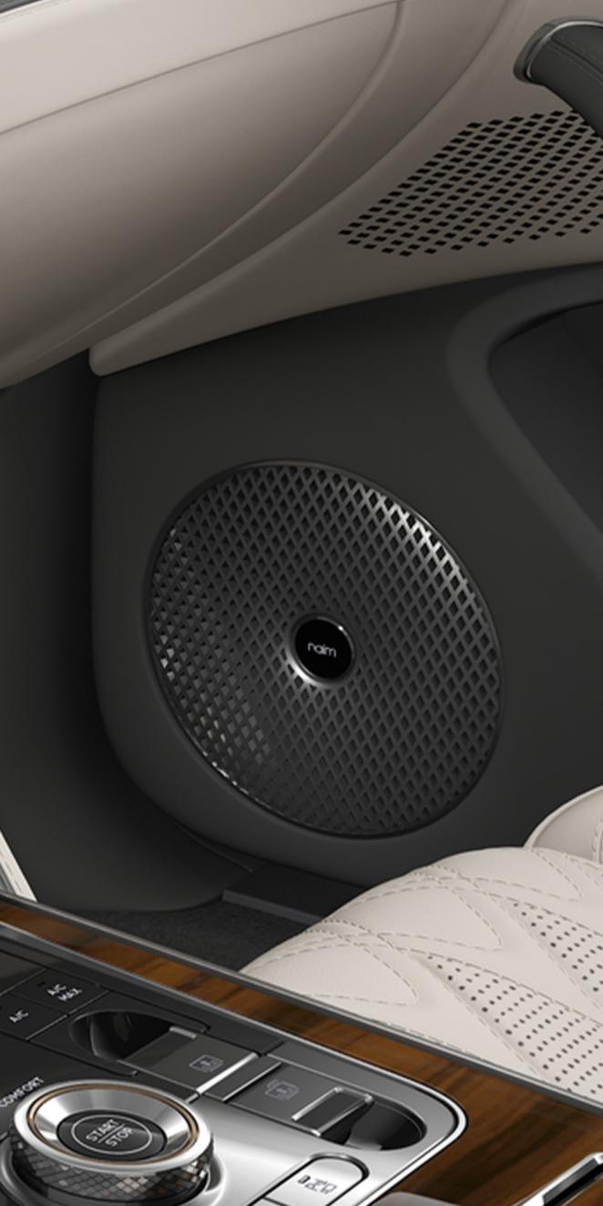 Close-up of the Naim speaker inside the Bentley Flying Spur Azure with Linen and Gravity Grey interior trim.