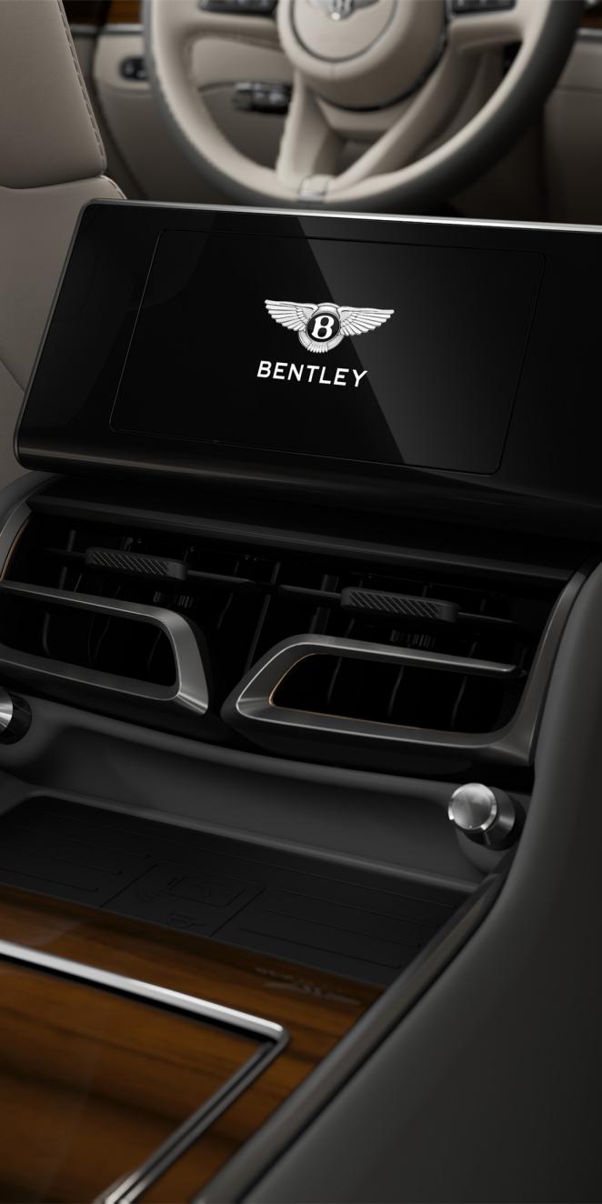 Rear passenger digital screen inside the Bentley Flying Spur Azure with Linen and Gravity Grey cabin trim.
