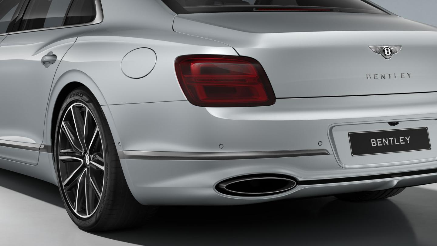 Rear three-quarter close-up of the Bentley Flying Spur showing the rear lights, exhaust finishers and Bright Chrome Exterior detailing.