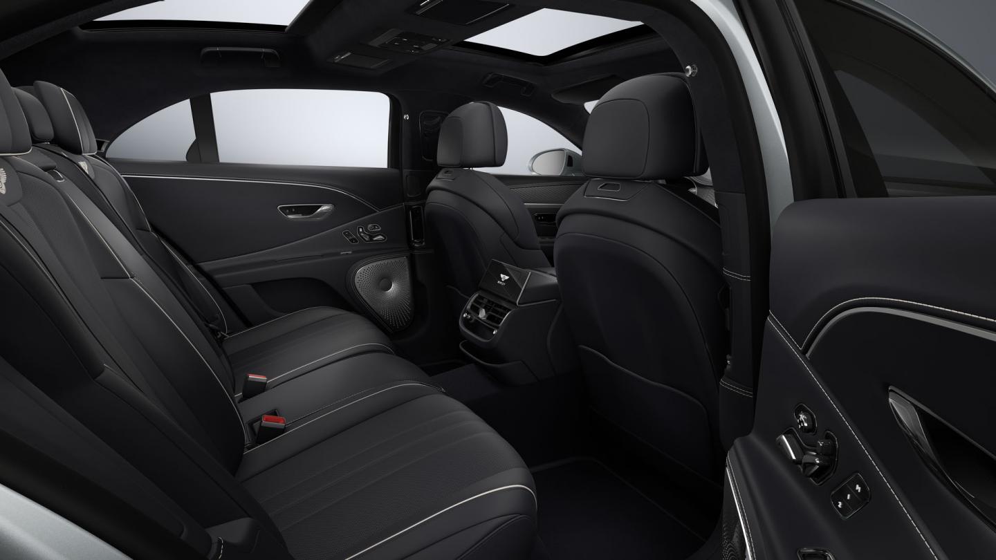 Side view from the rear passenger door into the Bentley Flying Spur showing the Imperial Blue interior and 4+1 seat configuration.