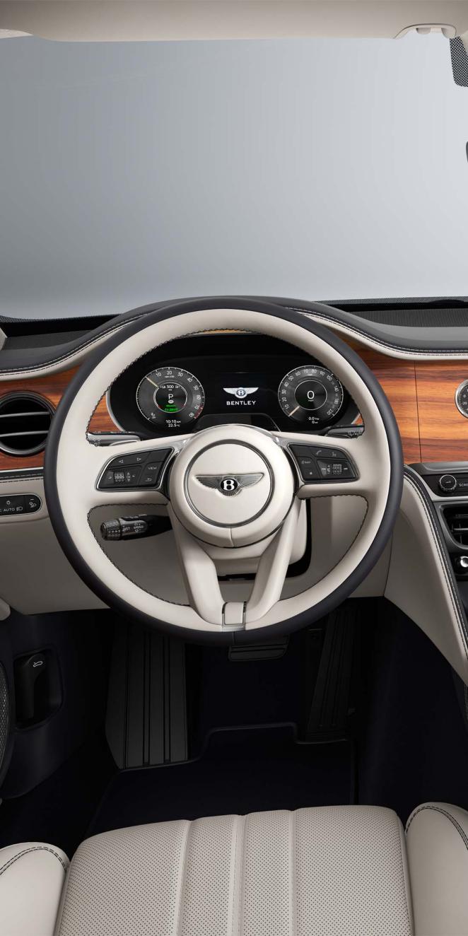Driver’s view of the Bentley Flying Spur steering wheel with Linen / Imperial Blue interior.