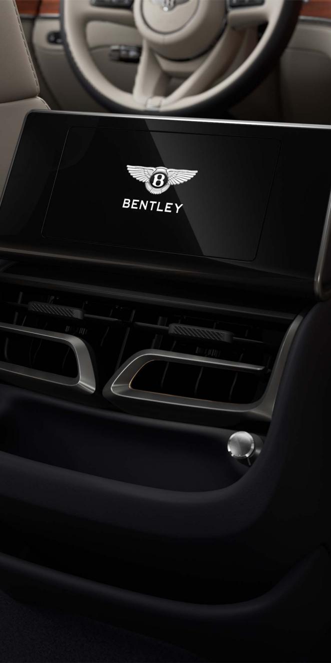 Rear passenger digital screen inside the Bentley Flying Spur with Linen and Imperial Blue cabin trim.