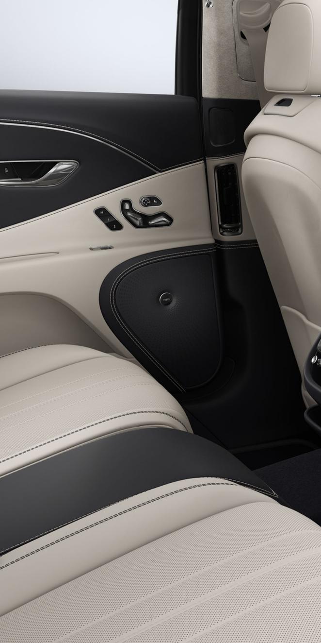 Close-up of the Naim speaker inside the Bentley Flying Spur with Linen and Imperial Blue interior trim.