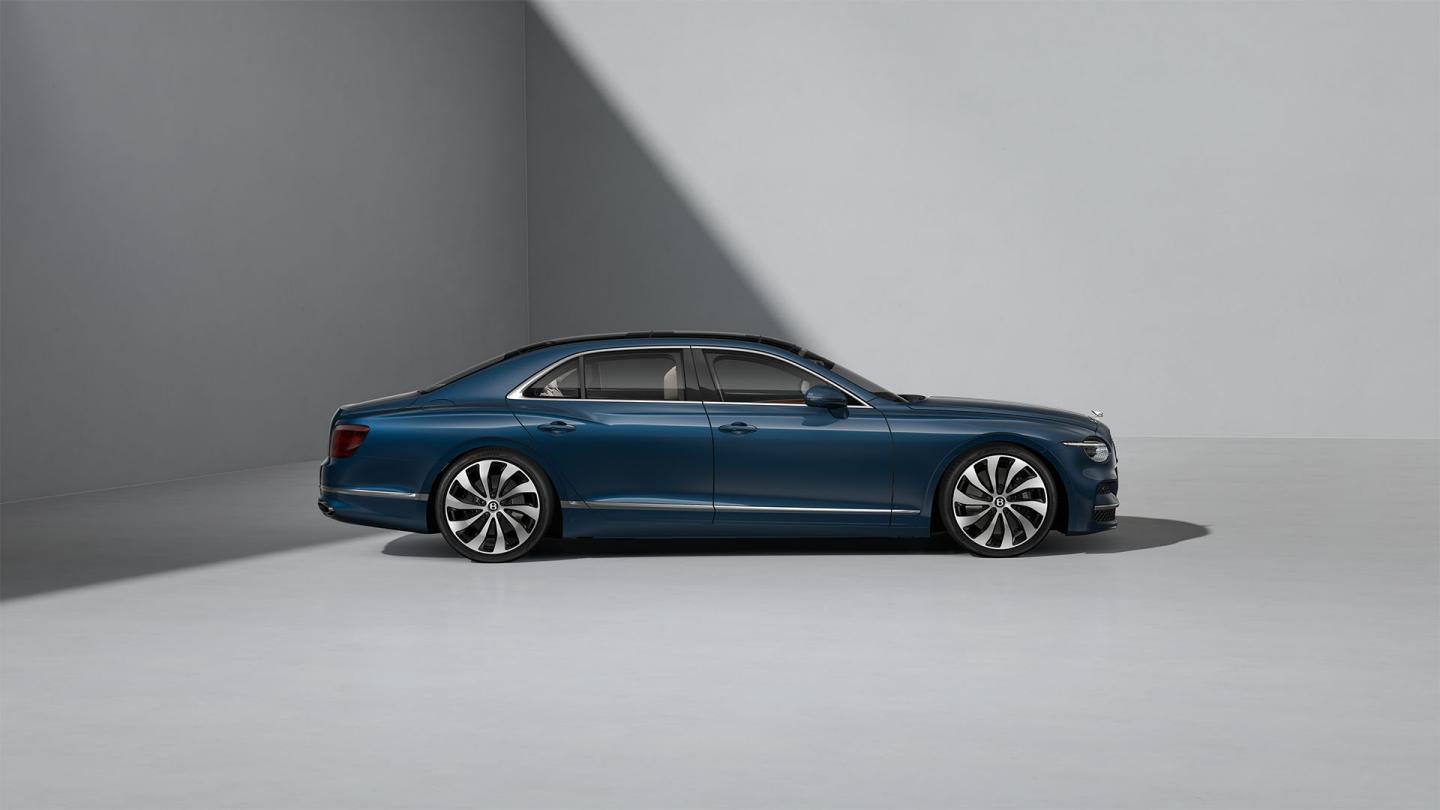 Side profile shot of the Bentley Flying Spur in Marlin with Bright Chrome Exterior detailing.