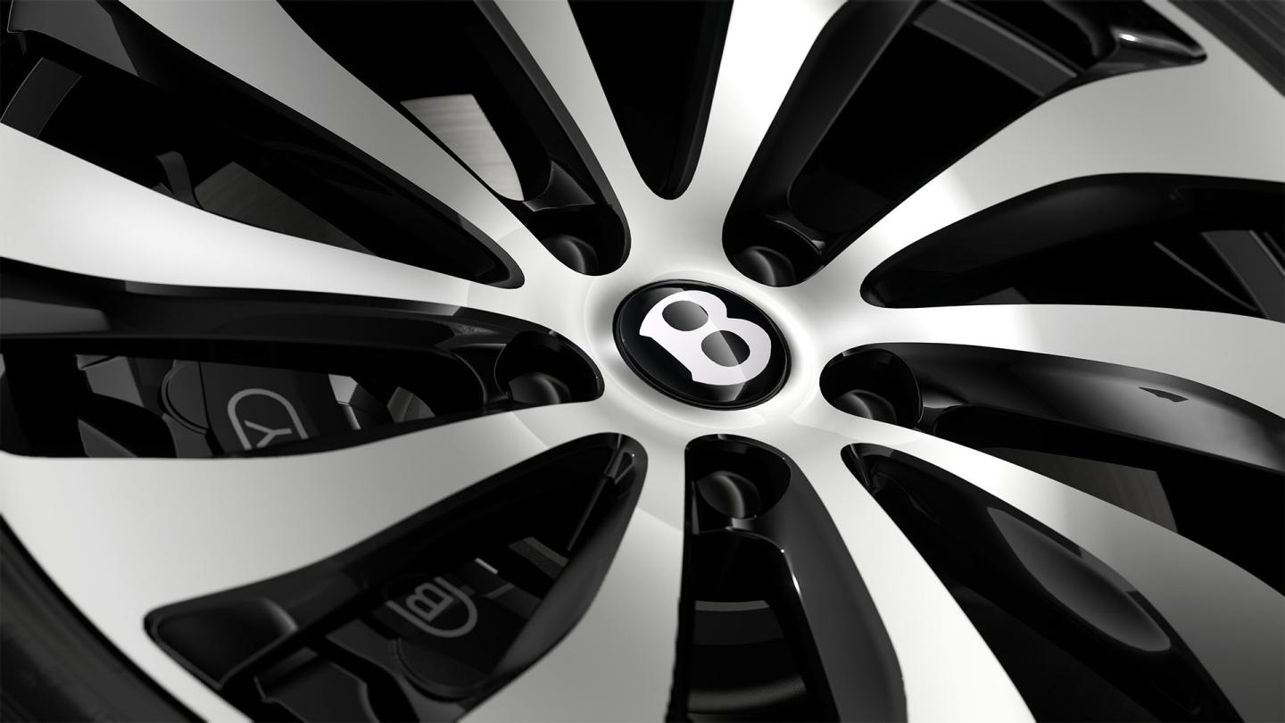 Close-up of the Bentley Flying Spur 22" Ten Spoke Wheel painted in black and bright machined.