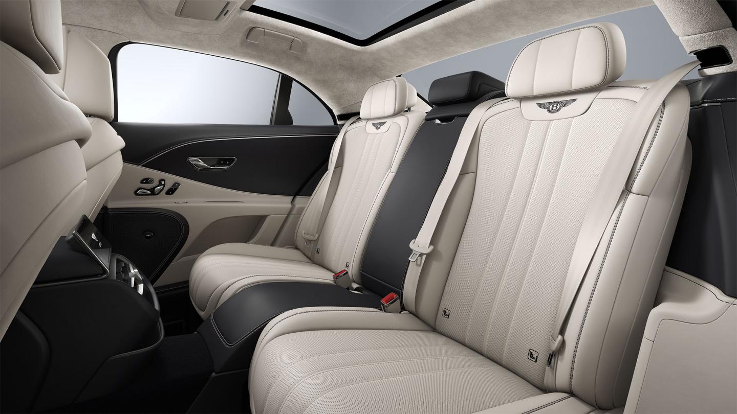 Rear passenger seat view inside the Bentley Flying Spur with Linen and Imperial Blue upholstery and 4+1 seat configuration.