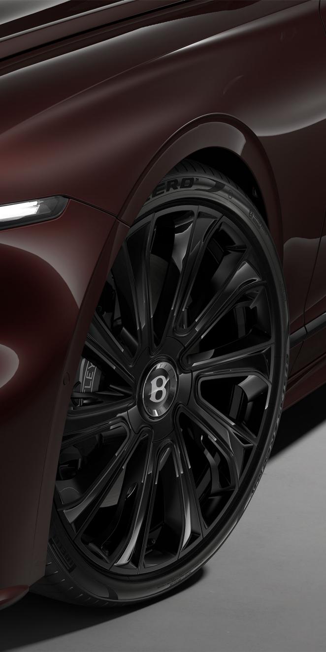 Close-up of the Bentley Flying Spur Mulliner 22" Mulliner wheel painted in black.