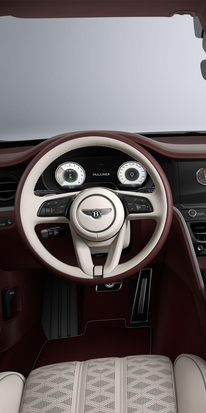 Driver’s view of the Bentley Flying Spur Mulliner steering wheel with Linen, Cricket Ball and Stratos interior trim.