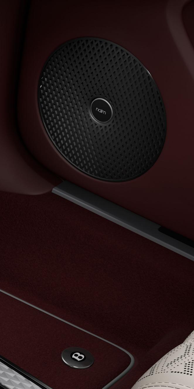 Close-up of the Bang & Olufsen speaker inside the Bentley Flying Spur Mulliner with Linen, Cricket Ball and Stratos interior trim.