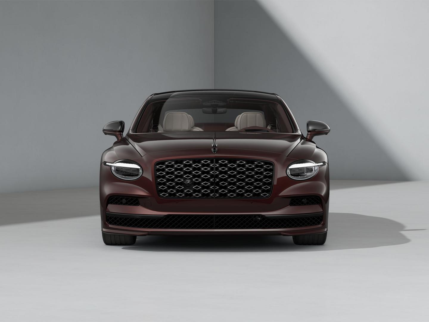 Front-on shot of the Bentley Flying Spur Mulliner in Cricket Ball with Blackline Specification and dark exterior detailing.