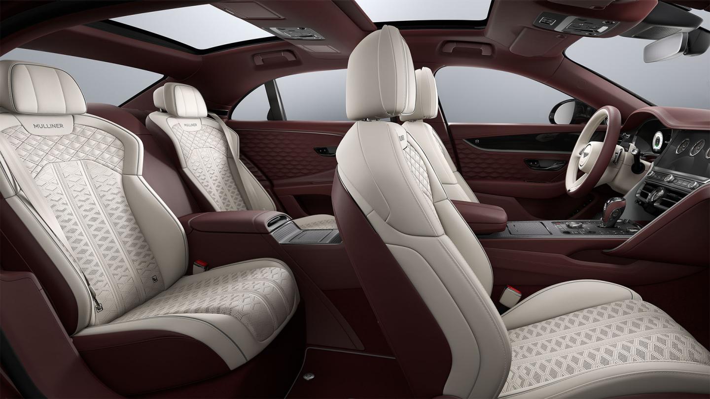 Side view from the rear passenger door into the Bentley Flying Spur Mulliner showing the Linen, Cricket Ball and Stratos interior and 4 seat configuration.