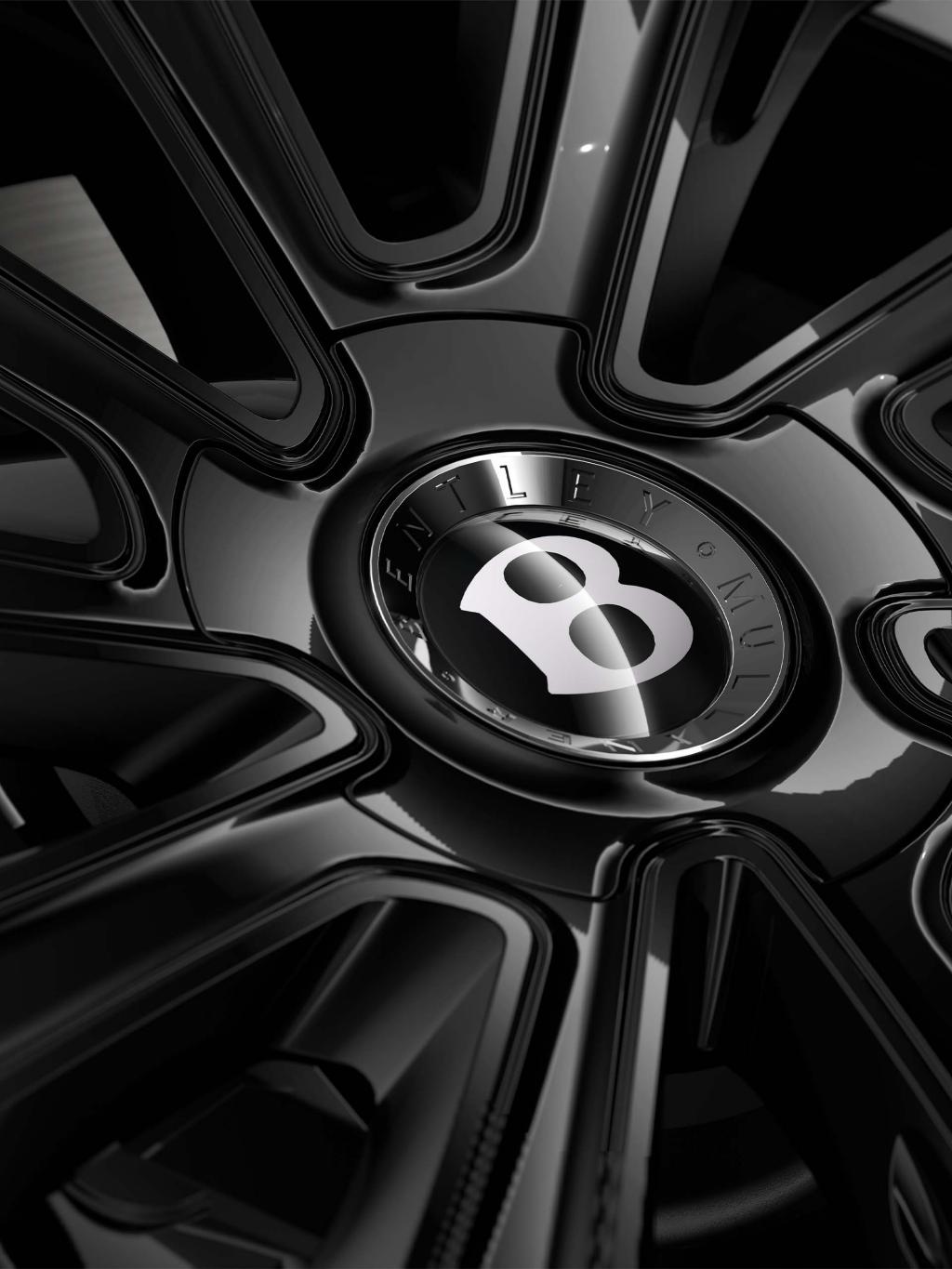 Close-up of the Bentley Flying Spur Mulliner 22" Mulliner wheel painted in black.