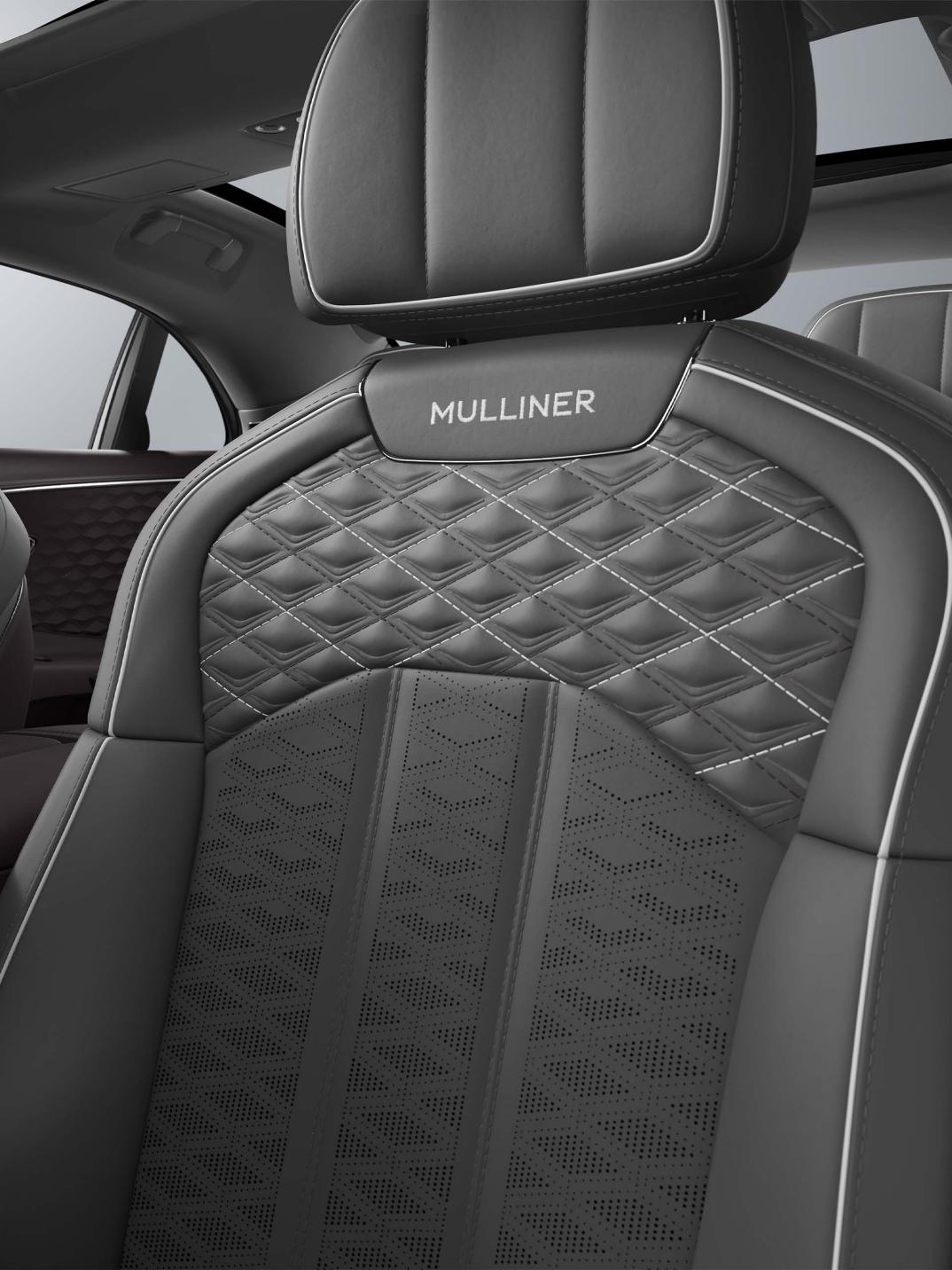 Interior view of the Bentley Flying Spur Mulliner driver’s seat in Gravity Grey, Damson and White.