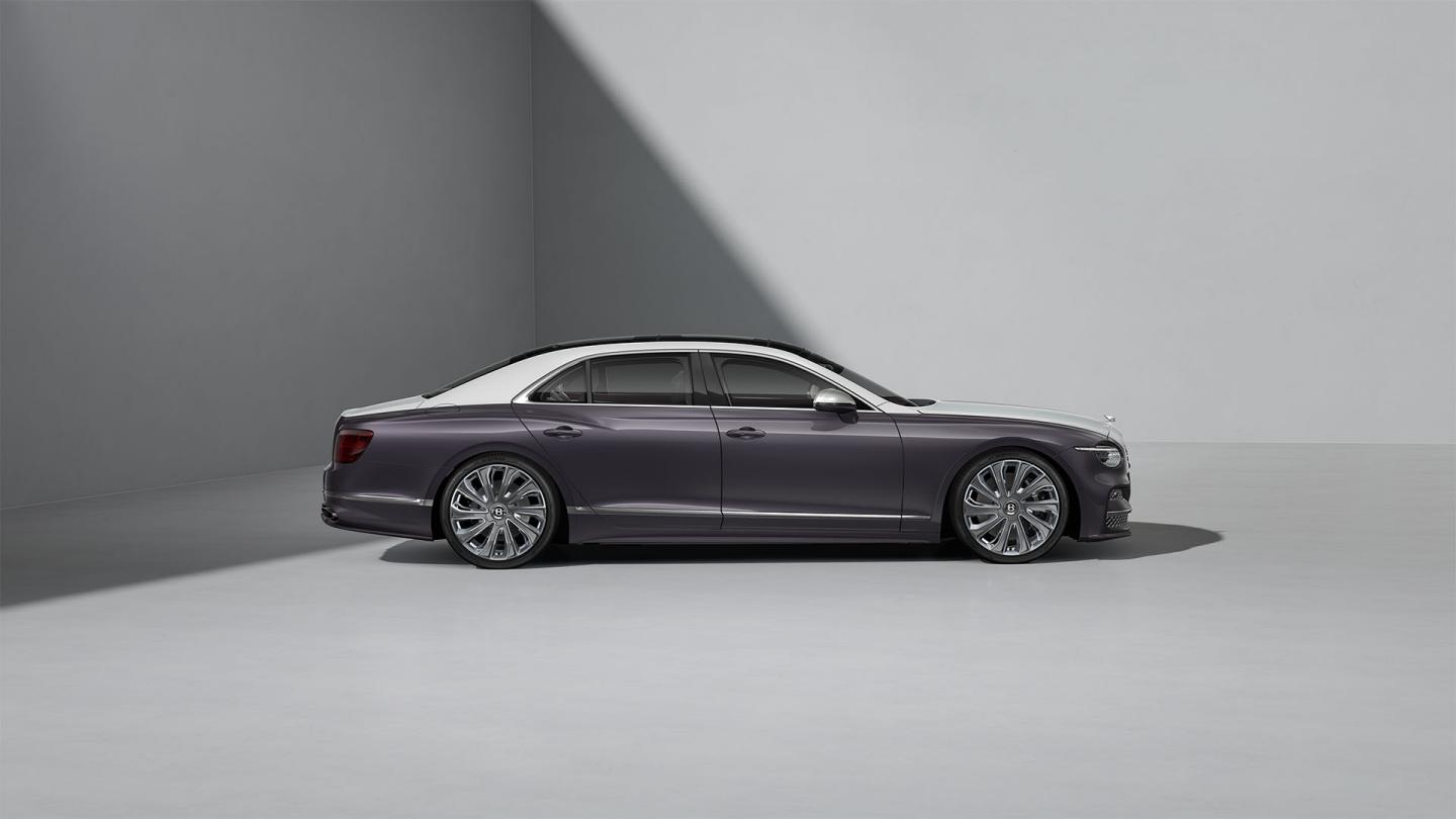 Side profile shot of the Bentley Flying Spur Mulliner in Ice / Grey Violet with Bright Chrome detailing, Satin Silver mirror caps and Carbon Styling Spec.