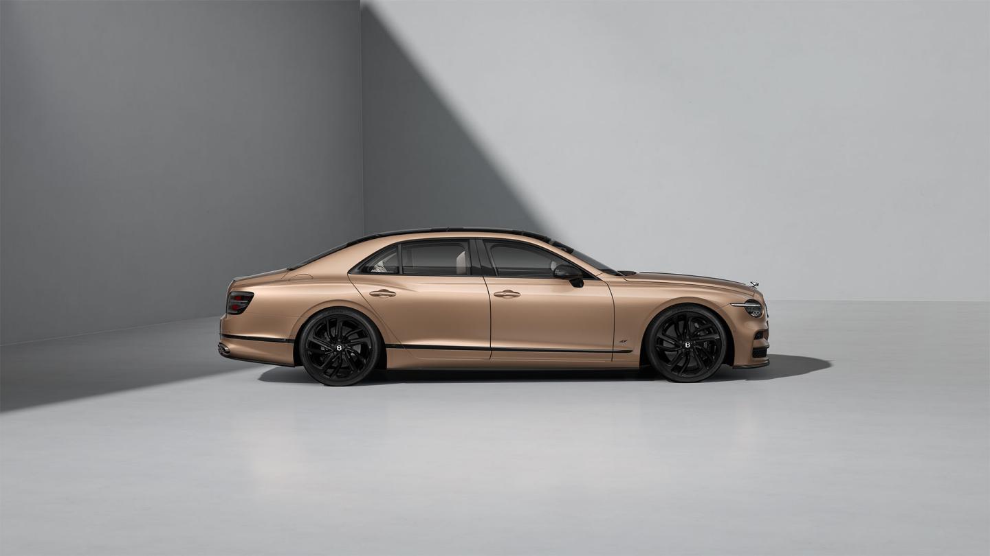 Side profile shot of the Bentley Flying Spur S in Rose Gold with Blackline Specification and Carbon Styling Spec.