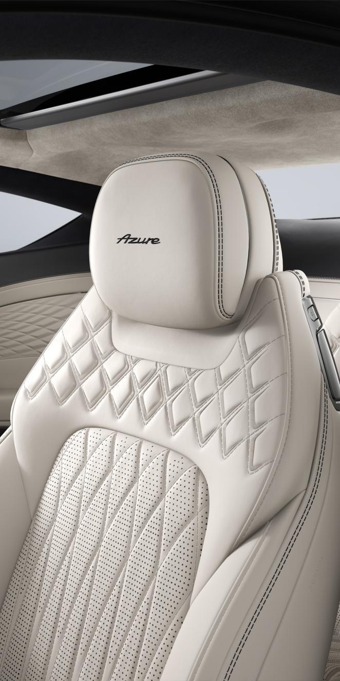 Interior view of the Bentley Continental GT Azure featuring seats upholstered in Linen and Cumbrian Green hide.