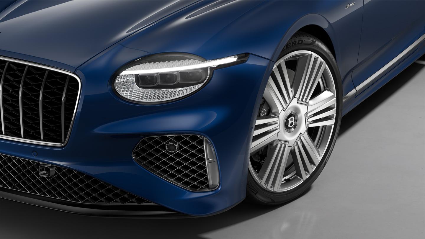 Close up of the headlights on the Bentley Continental GT Azure in Moroccan Blue, shown with 22" Azure Wheel painted in Silver and Bright Machined.