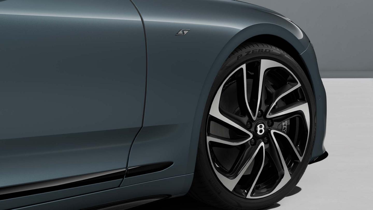 Close up of the front haunch of a Continental GT S in Thunder Grey with a close up of the 22inch directional five spoke wheel and S badging