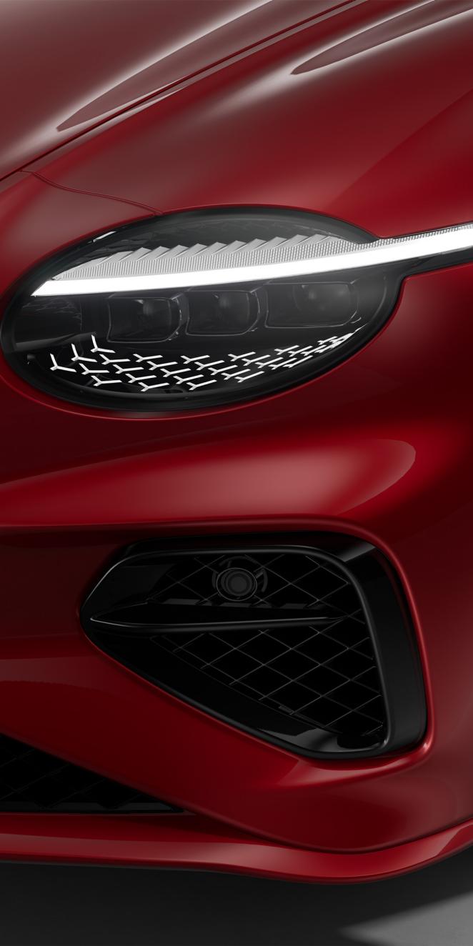 Close up of the headlights on the Bentley Continental GT Speed painted in Monaco Yellow.