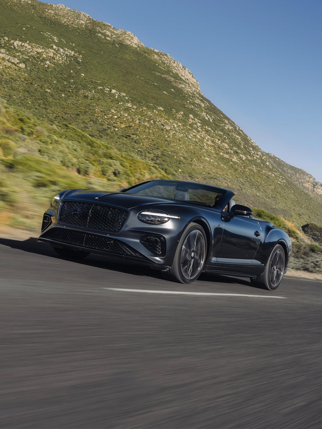 Close up front profile of the new Continental GTC S driving dynamically on the open road