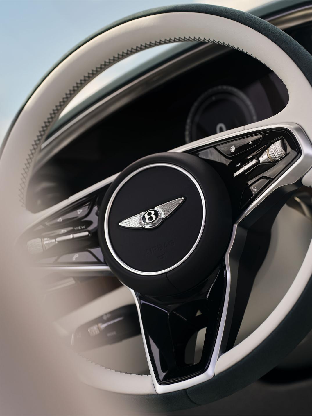 Close-up of the Bentley Torcal steering wheel with Glaze and Teal duo-tone trim.