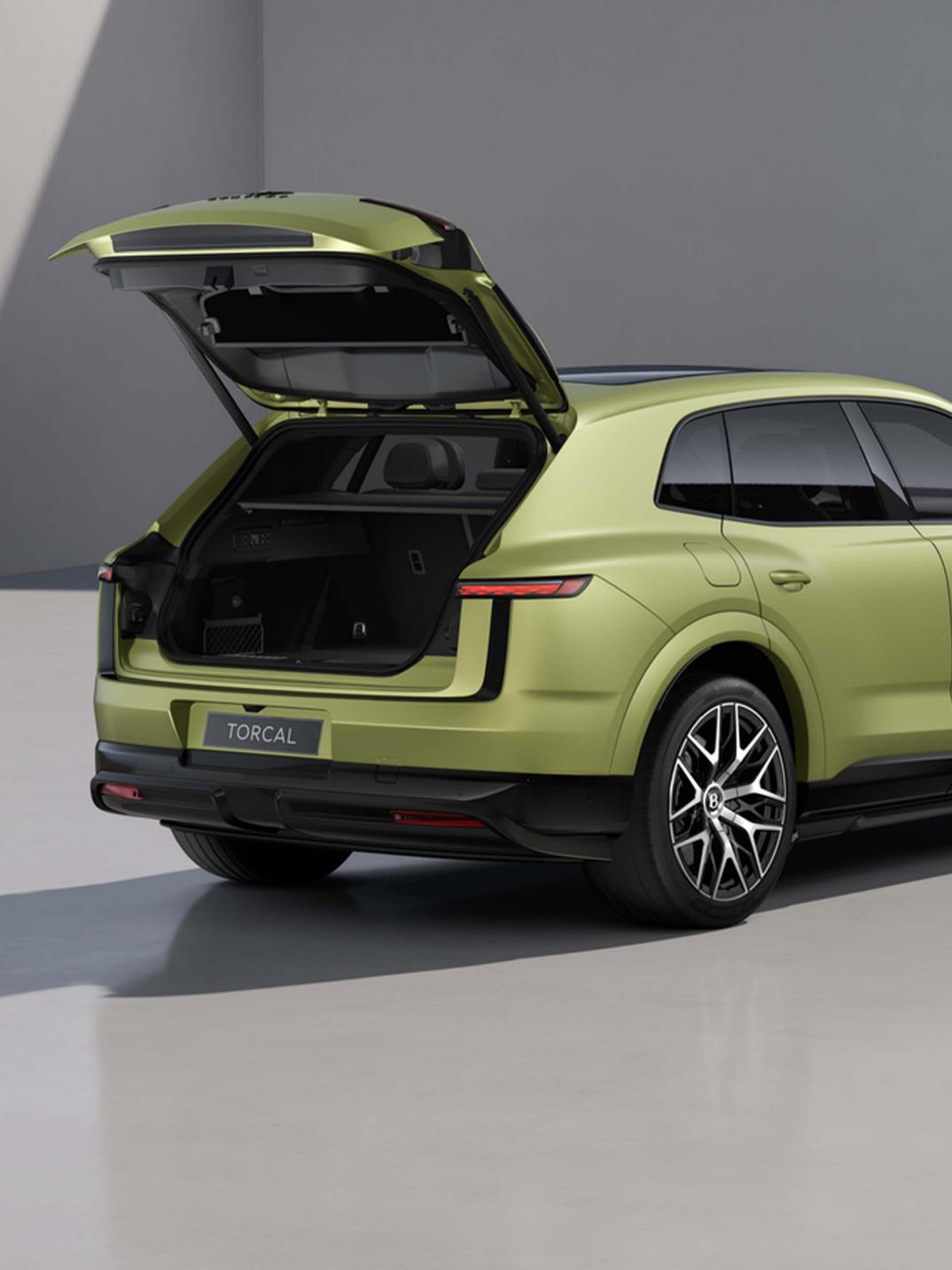 Rear three-quarter shot of the Bentley Torcal S in Electrum Satin with the tailgate open.