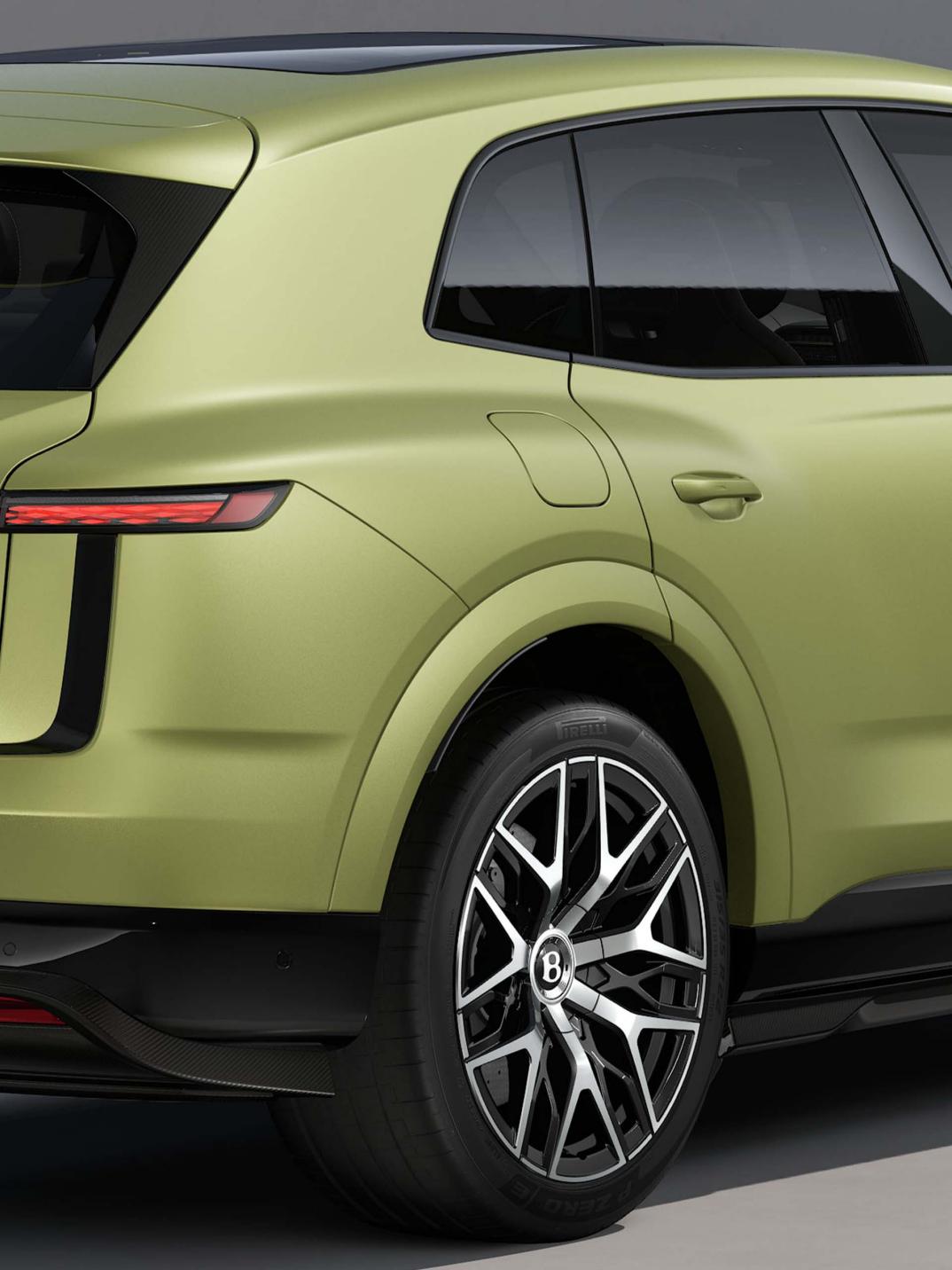 Rear three-quarter close-up of the Bentley Torcal S in Electrum Satin showing the rear lights and tailgate.