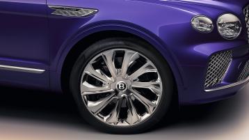 Bentley Bentayga EWB Mulliner in Tanzanite Purple colour one quarter view featuring 22 inch Mulliner Wheel - Polished and Mulliner double diamond wing vent.